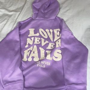 Purple “ Love never fails” sweatshirt
